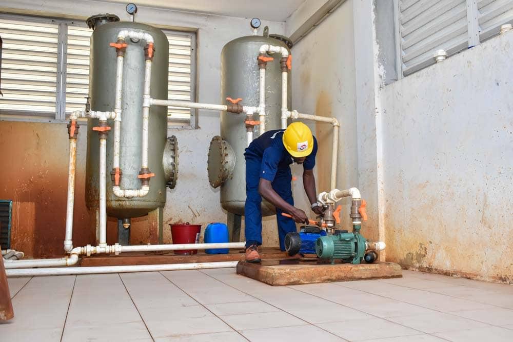 BOL Engineering technician maintaining water-treatment pumps and pipework